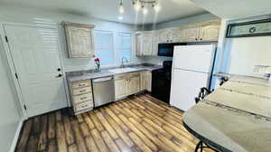 Kitchen featuring light brown cabinets, sink, hardwood / wood-style floors, and black appliances