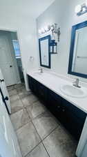 Bathroom with tile flooring and double vanity