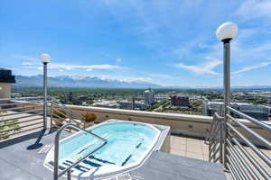 Exterior space with an in ground hot tub and a mountain view