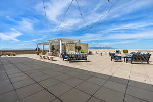 View of patio featuring a pergola, a mountain view, and an outdoor hangout area