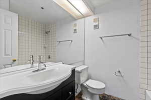 Bathroom with tile floors, oversized vanity, and toilet