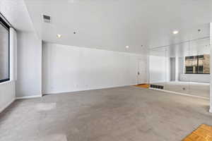 Unfurnished living room with light carpet