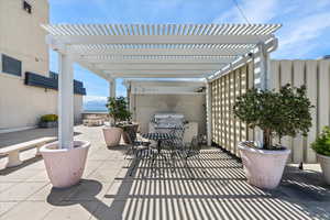 View of patio featuring a pergola and area for grilling