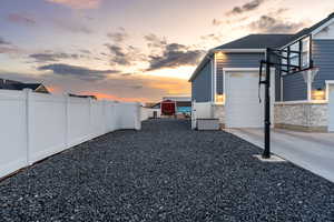 Yard at dusk featuring a garage