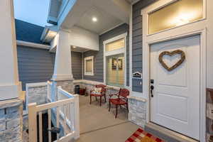 Entrance to property featuring covered porch