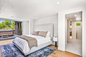 Bedroom featuring light hardwood / wood-style floors and access to exterior