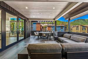 Wooden deck featuring outdoor lounge area, french doors, and a patio area