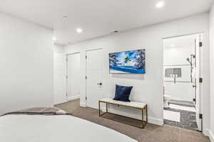 Bedroom with carpet and ensuite bath