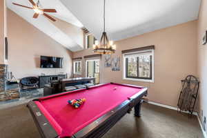 Rec room featuring high vaulted ceiling, carpet, billiards, and ceiling fan with notable chandelier