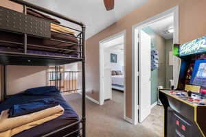 Carpeted bedroom with ceiling fan