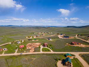 Birds eye view of property with a rural view and a mountain view