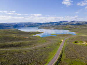 Birds eye view of property with a water and mountain view