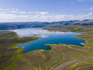 Drone / aerial view featuring a water and mountain view