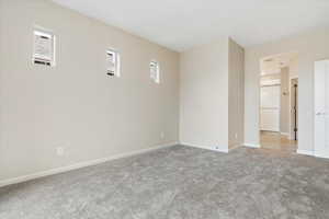 Spare room featuring light colored carpet