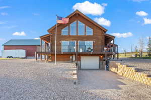 View of front of home featuring a garage and a wooden deck