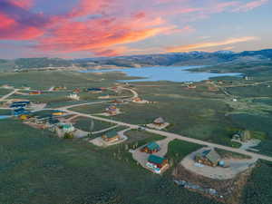 Aerial view at dusk featuring a rural view and a water and mountain view