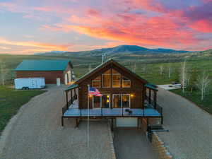 Cabin with a garage and a mountain view