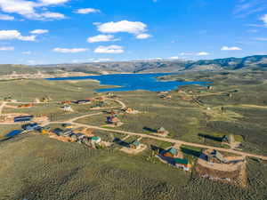 Birds eye view of property with a water and mountain view