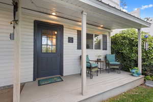 View of exterior entry to multi-use fitness studio with a porch