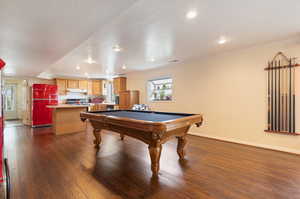 Rec room featuring billiards, dark hardwood / wood-style floors, and crown molding