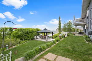 View of yard featuring a patio, a gazebo, and a balcony