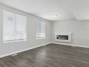 Unfurnished living room with dark hardwood / wood-style flooring