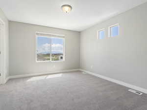 Carpeted spare room with plenty of natural light