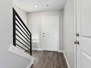 Foyer entrance featuring dark wood-type flooring