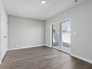 Empty room with hardwood / wood-style floors