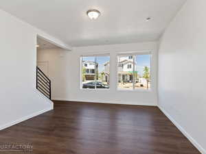 Spare room with dark hardwood / wood-style flooring