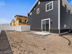 Back of house with a patio and central air condition unit