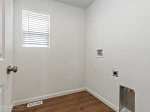 Washroom with hookup for an electric dryer, hardwood / wood-style flooring, and hookup for a washing machine