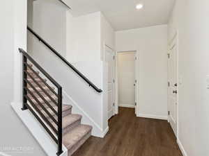 Foyer with dark hardwood / wood-style floors