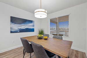 Dining space with hardwood / wood-style flooring