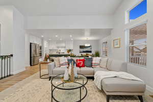 Living room with sink and light hardwood / wood-style floors