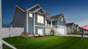 View of front of home featuring a yard and a garage