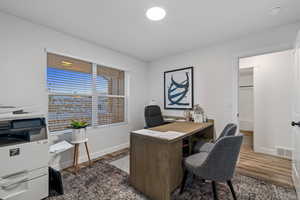 Office with dark wood-type flooring