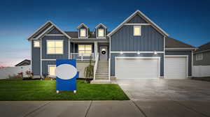 View of front of house with a garage and a lawn