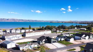 Birds eye view of property with a water and mountain view