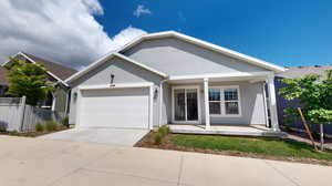 View of rear of house featuring a covered patio and garage