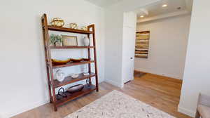 Sitting room with light hardwood / wood-style flooring