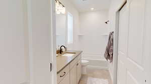 Full bathroom featuring tile flooring, toilet, bathtub / shower combination, and large vanity