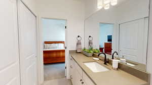 Ensuite bathroom with tile floors and large vanity