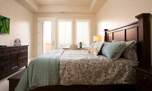 Bedroom with a raised ceiling and carpet floors