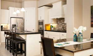 Kitchen with appliances with stainless steel finishes, decorative light fixtures, sink, tasteful backsplash, and custom exhaust hood