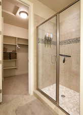 Bathroom featuring walk in shower and tile floors