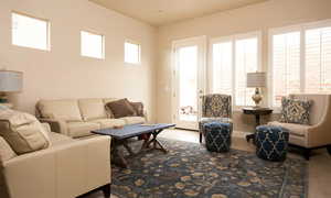 Tiled living room featuring a wealth of natural light