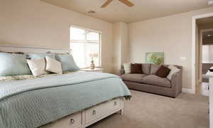 Tiled bedroom featuring ceiling fan