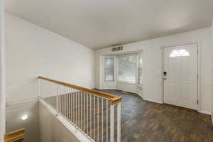 Foyer featuring dark hardwood / wood-style floors and plenty of natural light