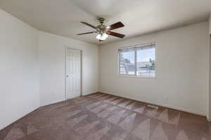 Spare room with carpet and ceiling fan